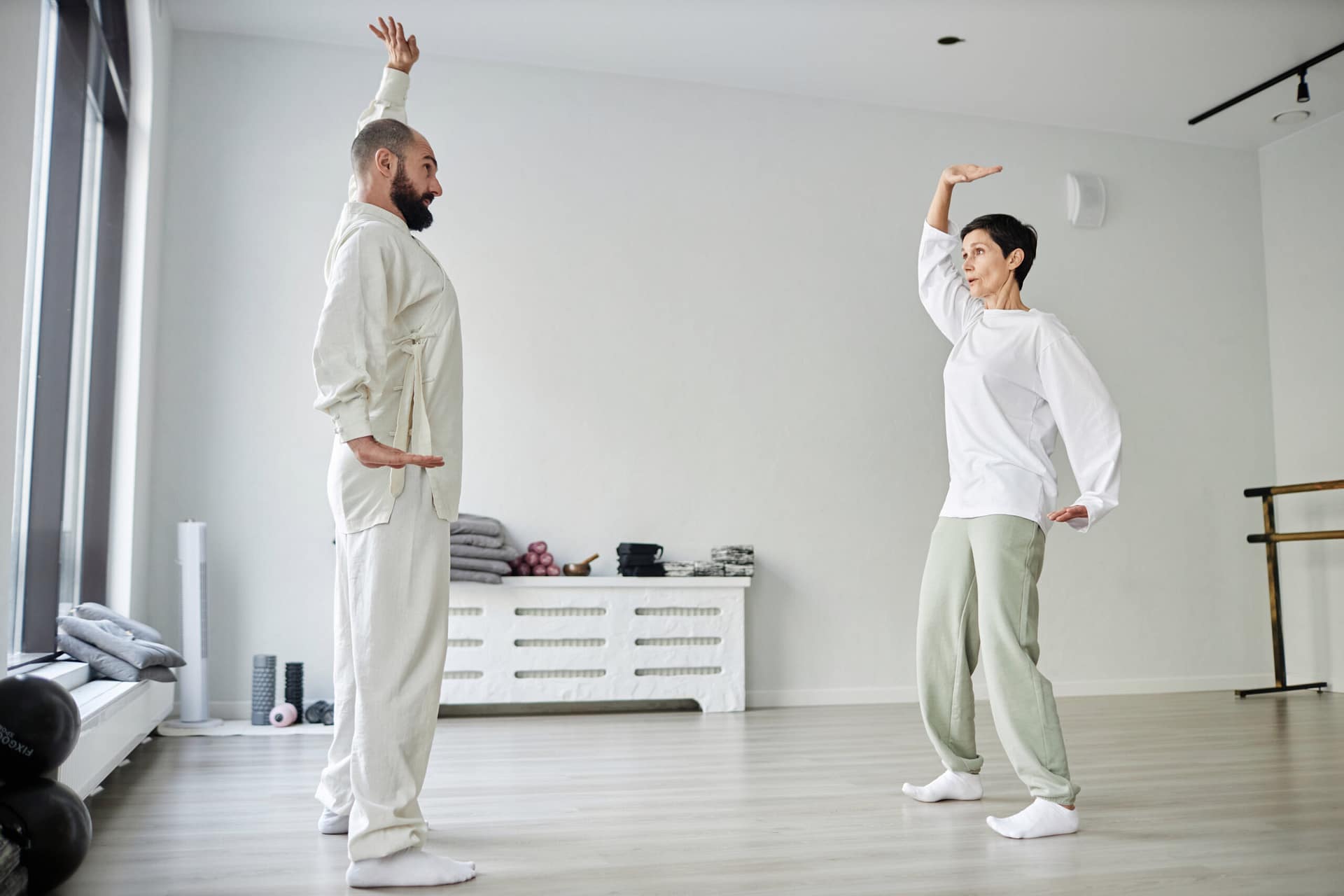 Woman and Instructor Exercising in Modern Gym